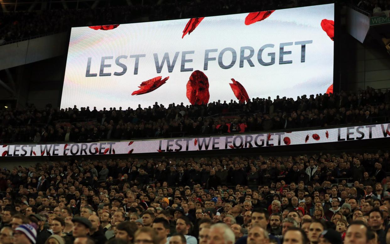 Fans at Wembley last year show their respects ahead of Remembrance Day last November  - PA Archive