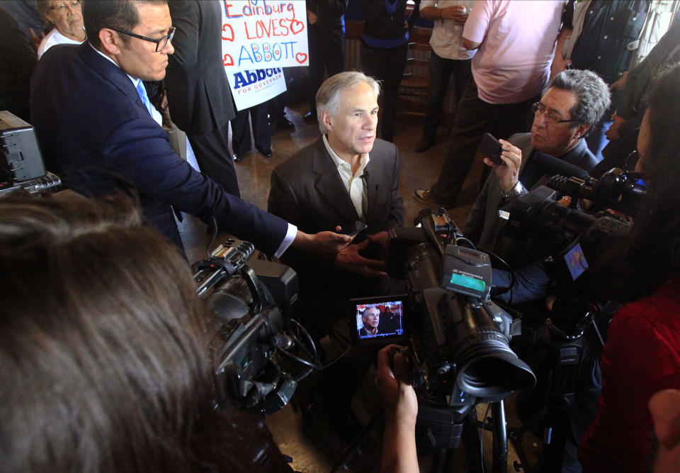 FILE - In this March 6, 2014, file photo, Texas Attorney General and Republican gubernatorial candidate Greg Abbott talks to the media at El Pato in Edinburg, Texas. Abbott would not sign a measure to make it easier for women to bring pay discrimination lawsuits in state court if he were governor, a spokesman said Wednesday, march 19, 2014, hoping to get past an issue that has dogged the campaign for weeks. (AP Photo/The Monitor, Gabe Hernandez, File) MAGS OUT; TV OUT