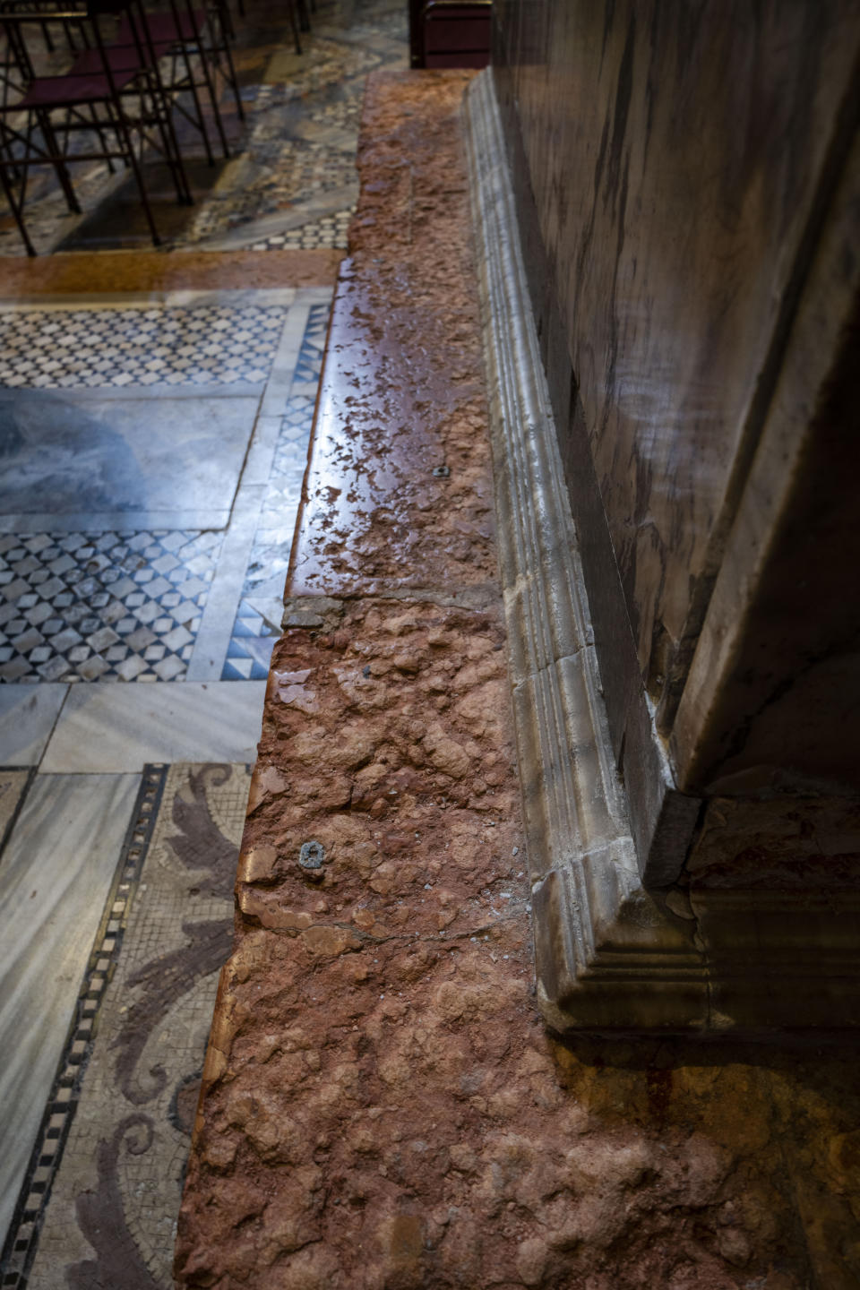 Signs of erosion are visible inside St. Mark's Basilica in Venice, northern Italy, Wednesday, Dec. 7, 2022. Glass barriers that prevent seawater from flooding the 900-year-old Venice's iconic Basilica during high tides have been recently installed. St. Mark's Square is the lowest-laying city area and frequently ends up underwater during extreme weather. (AP Photo/Domenico Stinellis)