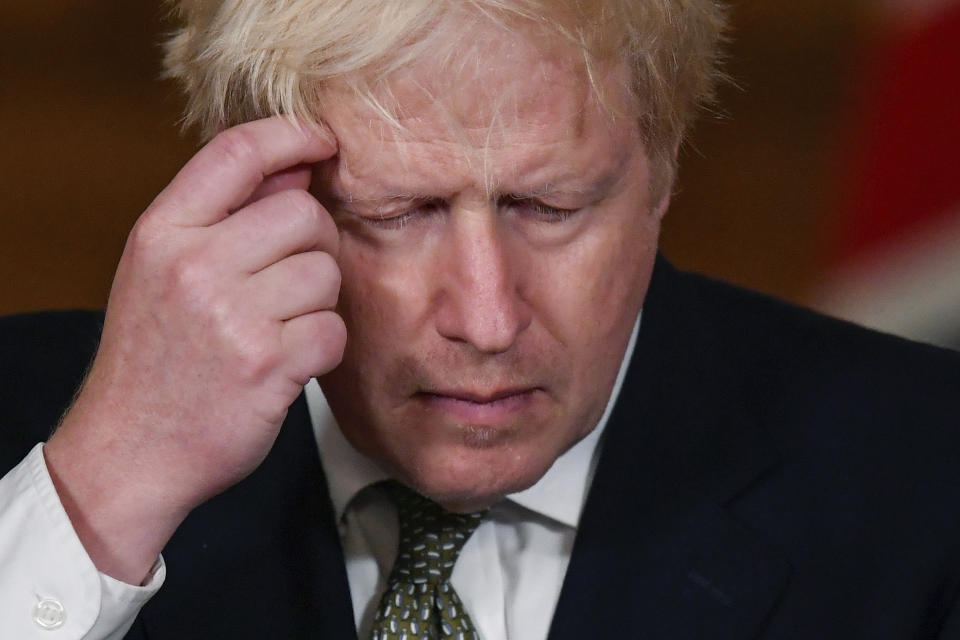 Britain's Prime Minister Boris Johnson gestures, during a coronavirus briefing in Downing Street, London, Monday, Oct. 12, 2020. (Toby Melville/Pool Photo via AP)