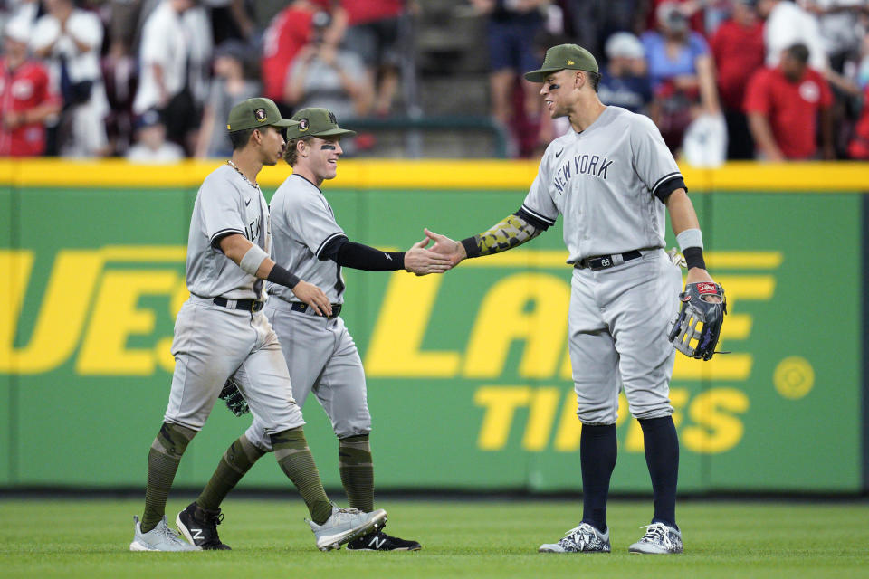 New York Yankees' Oswaldo Cabrera, Harrison Bader and Aaron Judge celebrate the team's win over the Cincinnati Reds in a baseball game in Cincinnati, Friday, May 19, 2023. (AP Photo/Jeff Dean)