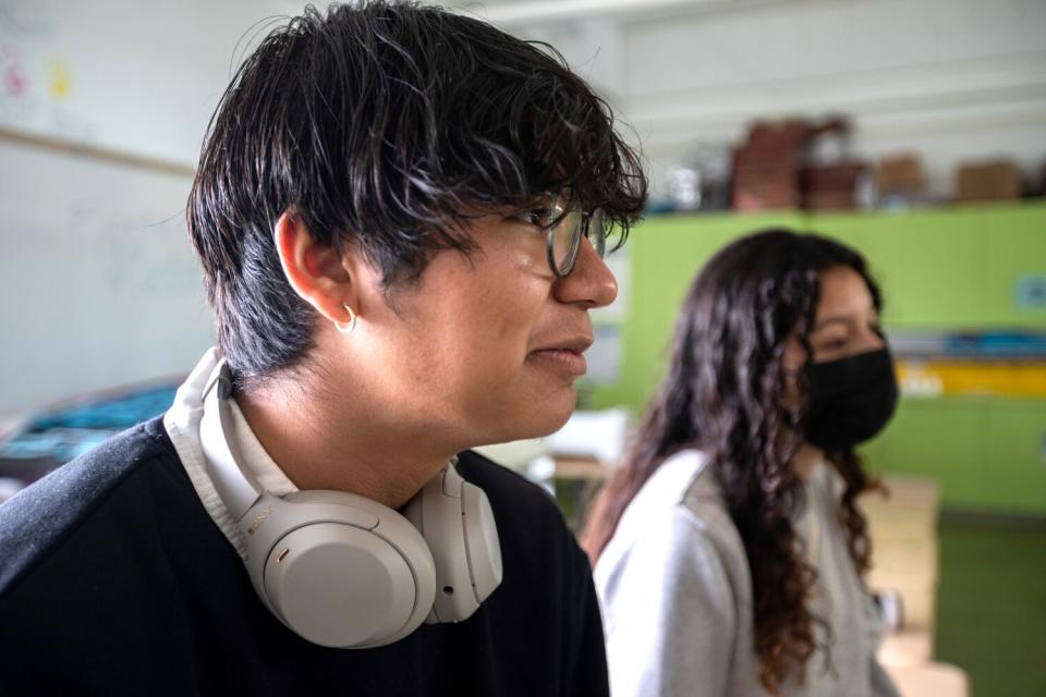 High school student Jonathan Cornejo smiles with a classmate nearby.