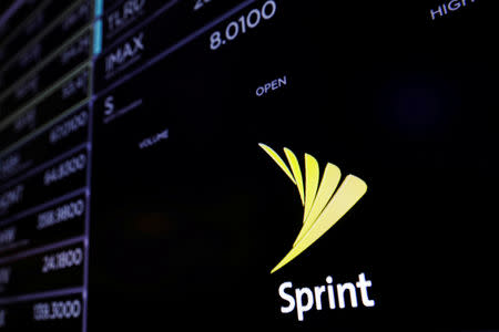 FILE PHOTO: A screen shows a Sprint logo above the floor of the New York Stock Exchange shortly before the opening bell in New York, U.S., June 27, 2017. REUTERS/Lucas Jackson