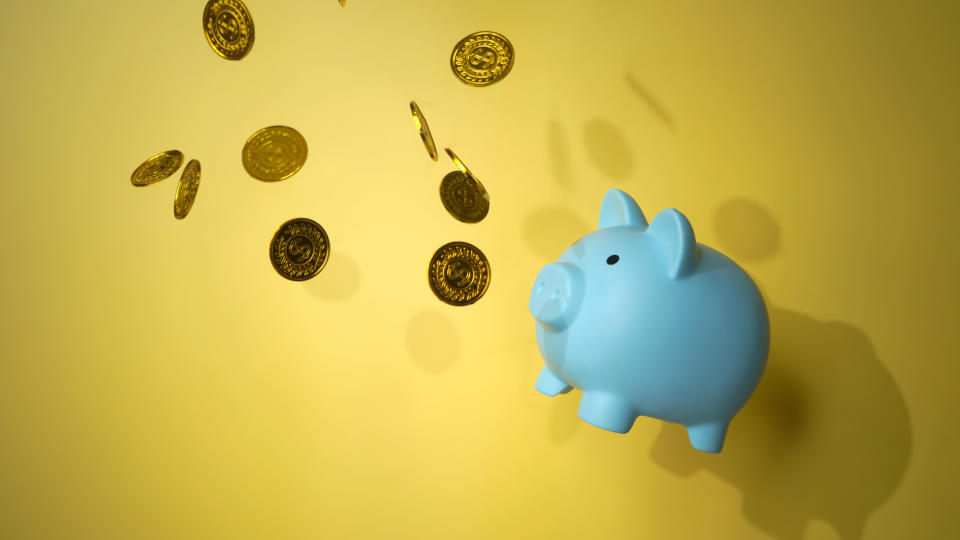 piggy bank flying  while chasing gold coins financial concept photo