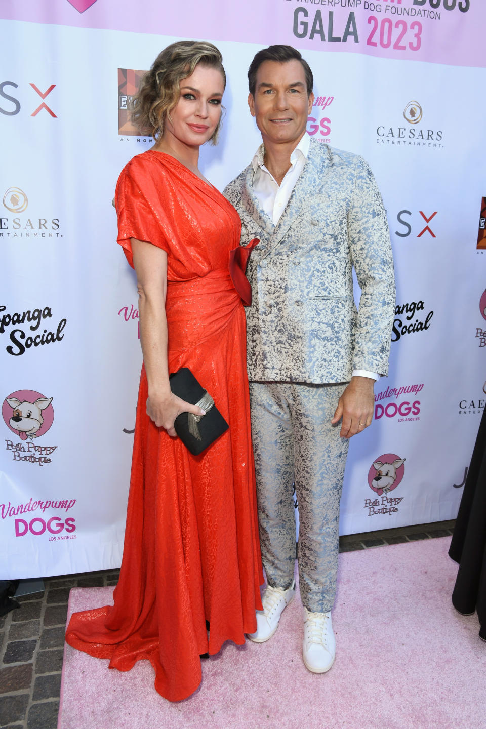 Rebecca Romijn in a red gown with Jerry O'Connell