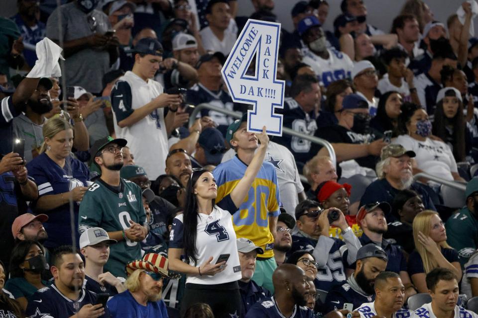 A fan holds up a sign that makes reference to Dallas Cowboys quarterback Dak Prescott (4) in the first half of an NFL football game against the Philadelphia Eagles in Arlington, Texas, Monday, Sept. 27, 2021. (AP Photo/Michael Ainsworth)