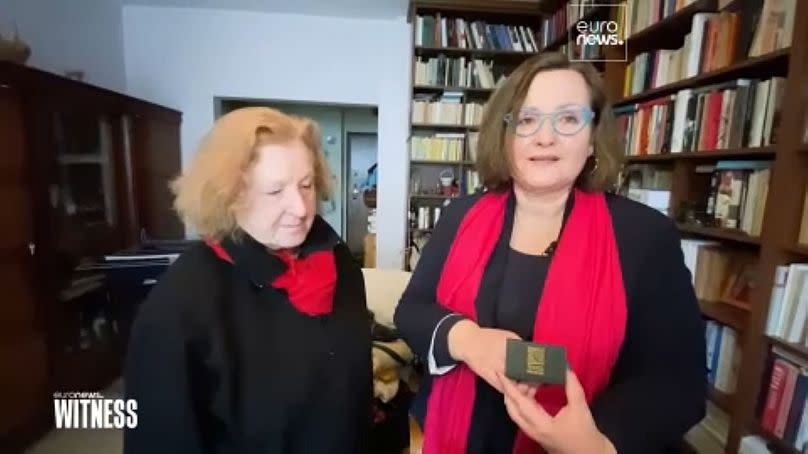 Publisher Elżbieta (L) with writer Renata (R) holding a box containing their wedding rings