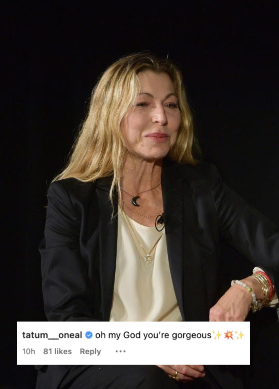 Tatum O'Neal sitting, wearing a blazer and top, with water bottles and microphones on the table during a discussion panel