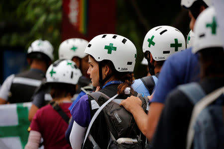 Volunteer members of the primary care response team watch as supporters rally against President Nicolas Maduro in Caracas, Venezuela, May 24, 2017. REUTERS/Carlos Garcia Rawlins