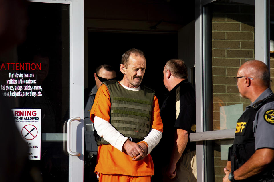 Kirby Gene Wallace exits the Stewart County Courthouse for his first appearance Tuesday, Oct. 9, 2018, in Dover, Tenn. Wallace, a multiple-murder suspect who led Tennessee law enforcement on an intense 7-day manhunt was captured without a struggle Friday morning, Oct. 5, in a wooded area about two hours northwest of Nashville. Wallace was wanted in two counties on charges that include murder, arson and kidnapping. (Courtney Pedroza/The Tennessean via AP, Pool)