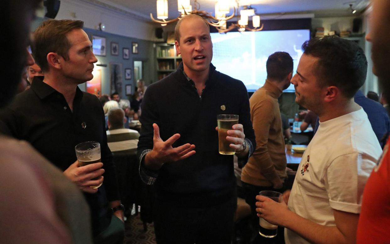 The Duke of Cambridge watches the football with football fans and Chelsea manager Frank Lampard, after discussing mental health as part of the Heads Up campaign - PA