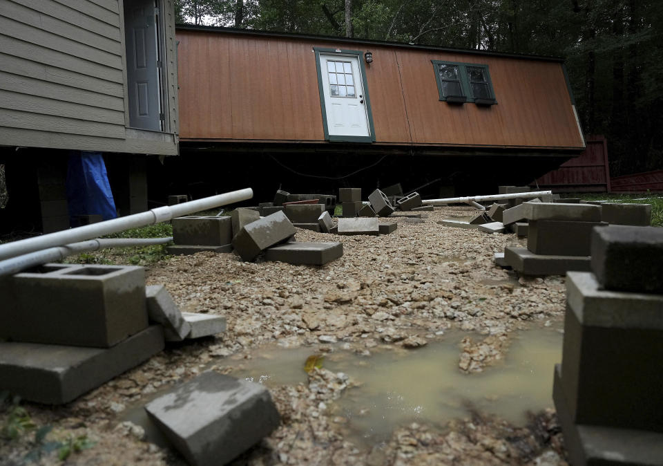 Dorothy and Earl Blevins' temporary home sits off its foundation after it was moved by flooded water and into the new home they are building on property once owned by Dorothy's mother on Sunday, May 5, 2024, in Spendora, Texas. "We've never flooded like this," said Dorothy. (Elizabeth Conley/Houston Chronicle via AP)