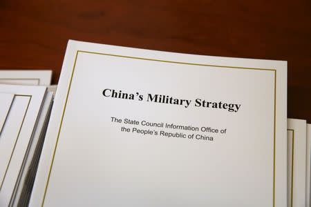 Copies of the annual white paper on China's military strategy are placed on a table for distribution to journalists during a news conference in Beijing, China, May 26, 2015. REUTERS/Kim Kyung-Hoon
