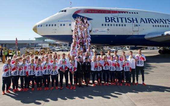 The British Olympic Team poses in front of a gold-tipped 747 (AFP via Getty)