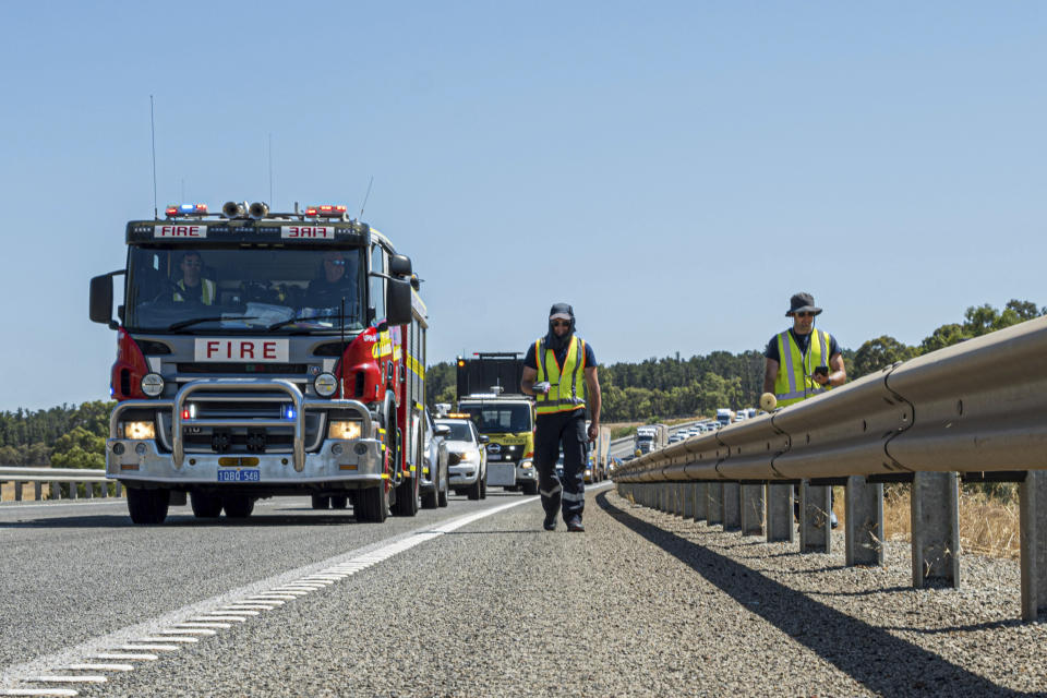 In this photo provided by the Department of Fire and Emergency Services, its members search for a radioactive capsule believed to have fallen off a truck being transported on a freight route on the outskirts of Perth, Australia, Saturday, Jan. 28, 2023. A mining corporation on Sunday apologized for losing the highly radioactive capsule over a 1,400-kilometer (870-mile) stretch of Western Australia, as authorities combed parts of the road looking for the tiny but dangerous substance. (Department of Fire and Emergency Services via AP)