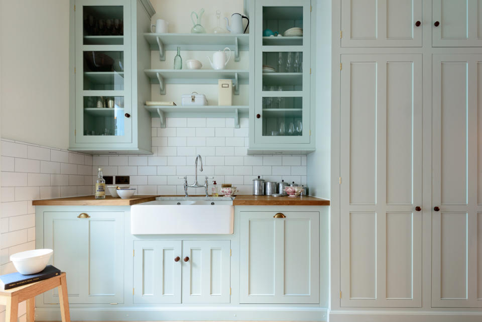 A kitchen with mint green cabinets