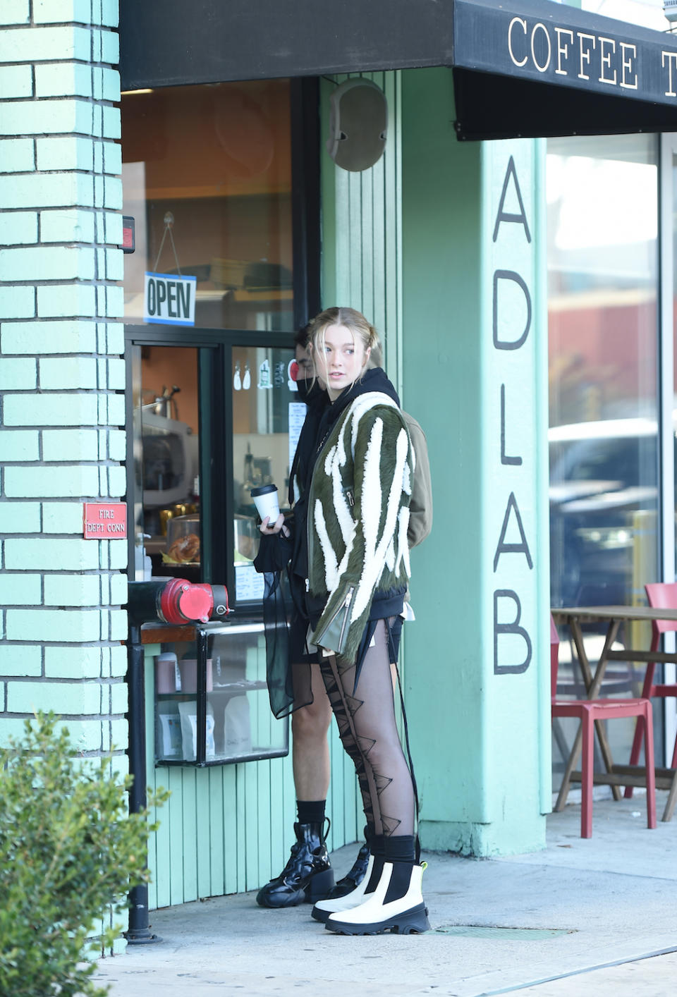 Hunter Schafer grabs coffee in a Rick Owens jacket and Sorel boots. - Credit: Jason Merritt/Radarpics/Shutterstock