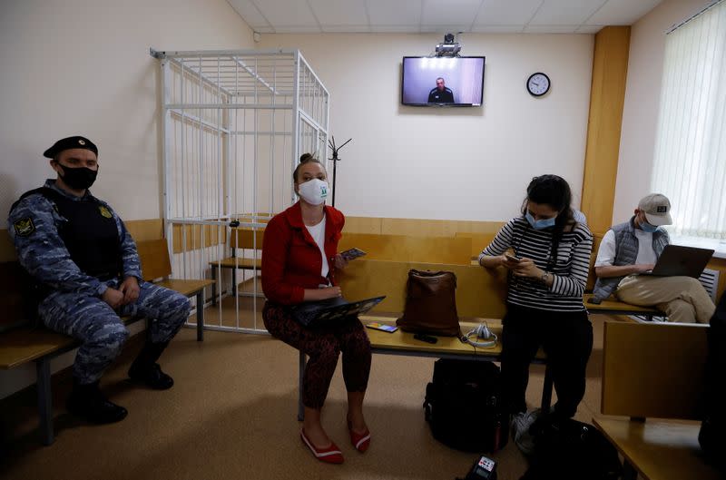 Russian opposition leader Alexei Navalny is seen on a screen via a video link during a hearing in Petushki