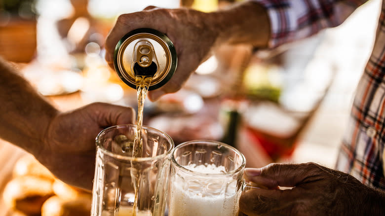 Pouring canned beer into mug