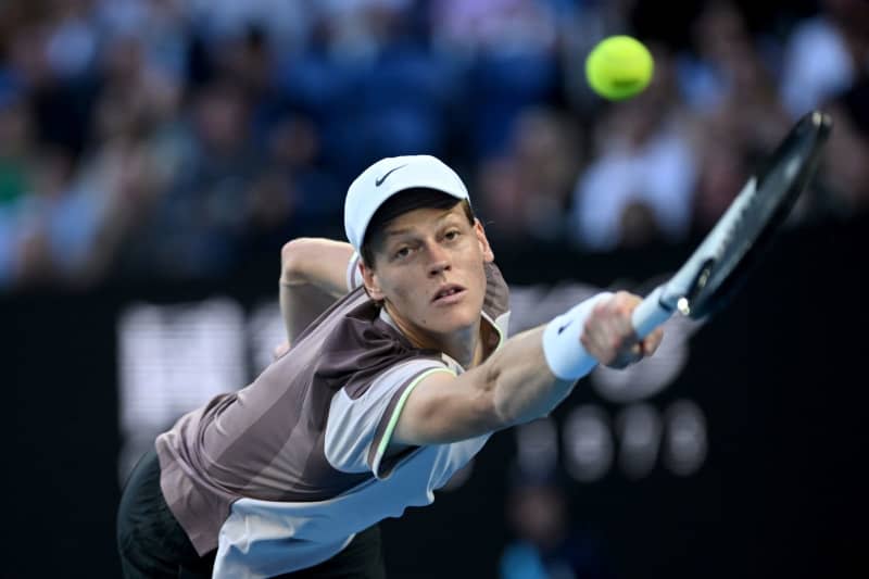 Italian tennis player Jannik Sinner in action against Russia's Daniil Medvedev during their Men’s Singles final tennis match of the 2024 Australian Open at Melbourne Park. Joel Carrett/AAP/dpa