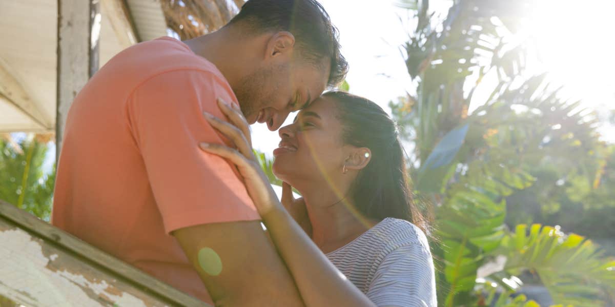 couple hugging in sunlight beam