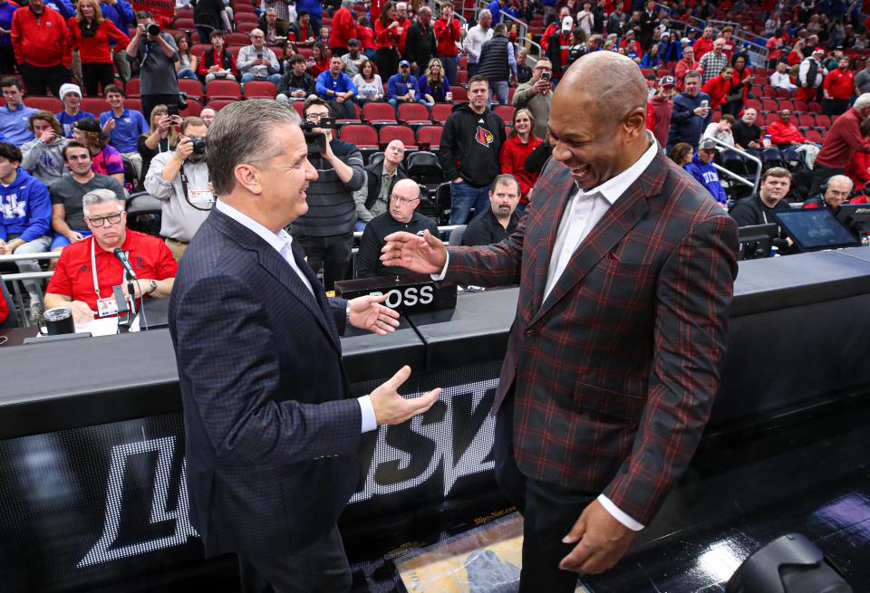 Kentucky’s John Calipari and Louisville coach Kenny Payne meet each other at mid court before the game between the two schools on Thursday, December 21, 2023