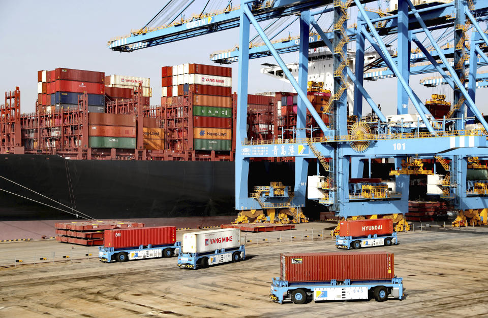 Automated vehicles move shipping containers in a container port in Qingdao in eastern China's Shandong Province, Thursday, Jan. 12, 2021. The U.S.-Chinese trade war isn't going away under President Joe Biden. Biden won't confront Beijing right away, economists say, because he needs to focus on the coronavirus and the economy. However, Biden looks set to renew pressure over trade and technology complaints that prompted President Donald Trump to hike tariffs on Chinese imports in 2017. (Chinatopix via AP)