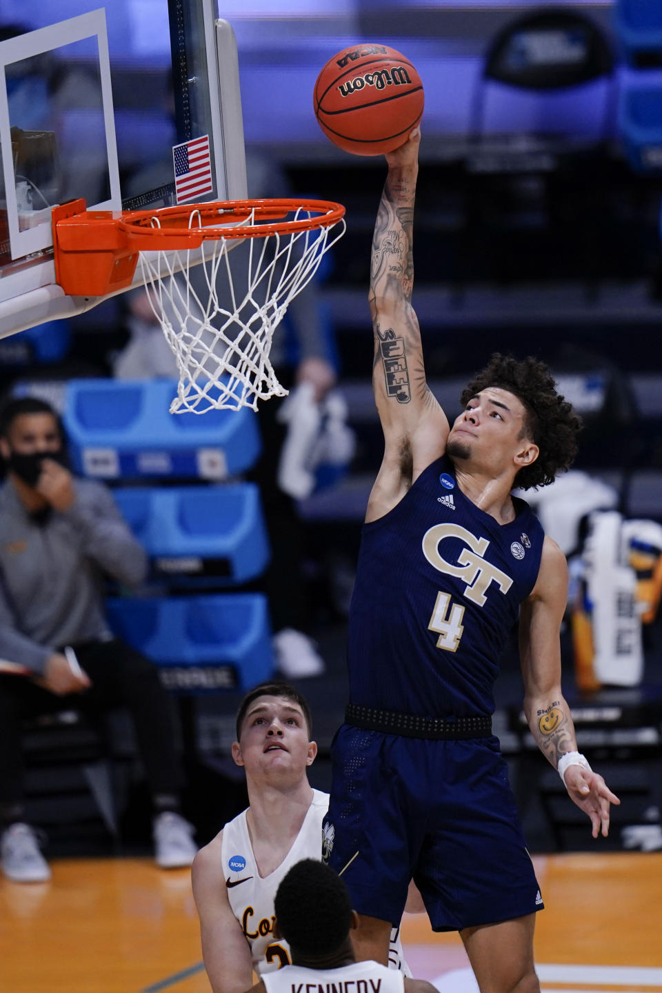 Georgia Tech guard Jordan Usher (4) dunks in front of Loyola Chicago guard Tate Hall in the first half of a college basketball game in the first round of the NCAA tournament at Hinkle Fieldhouse, Indianapolis, Friday, March 19, 2021. (AP Photo/AJ Mast)