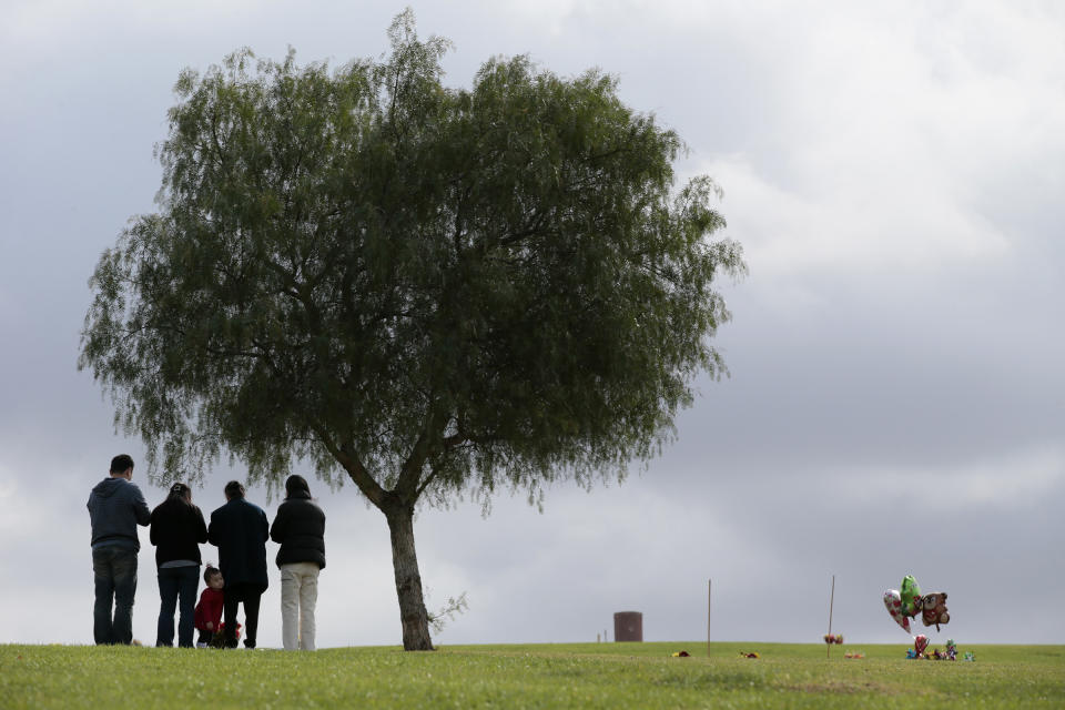 WHITTIER, CA, FRIDAY, JANUARY 31, 2014 - Three generations of the Tsai family pray over the grave of Wei Tsai at Rose Hills Cemetery. To celebrate the Chinese New Year, hundreds of families are coming to Rose HIlls to adorn graves, burn incense and pray.  (Photo by Robert Gauthier/Los Angeles Times via Getty Images)