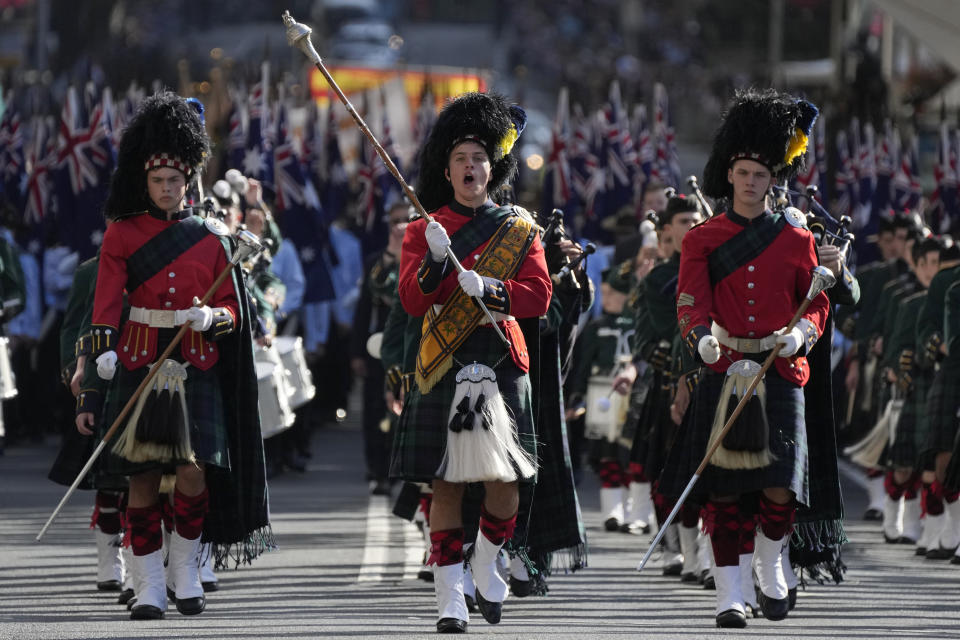 A drum major, center, leads his band in the Anzac Day parade in Sydney, Tuesday, April 25, 2023. (AP Photo/Rick Rycroft)