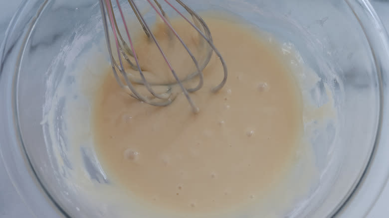 glaze in a bowl with a whisk