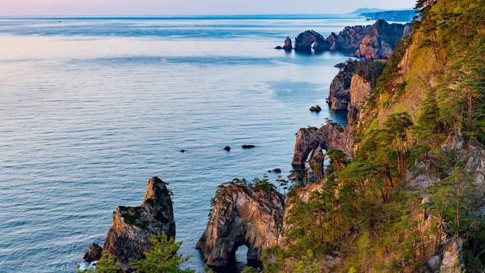 The cliffs of Kitayamazaki take on a reddish hue in the morning sun. - I love Photo and Apple./Moment RF/Getty Images