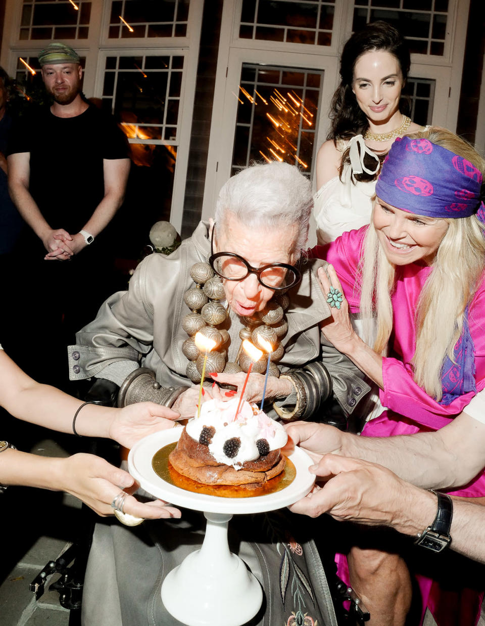 <p>Iris Apfel — turning 101! — blows out the candles on her cake with help from Christie Brinkley and Alexa Ray Joel at the EPIX and Cinema Society screening of <em>My Life as a Rolling Stone </em>in The Hamptons, New York, on Aug. 30.</p>