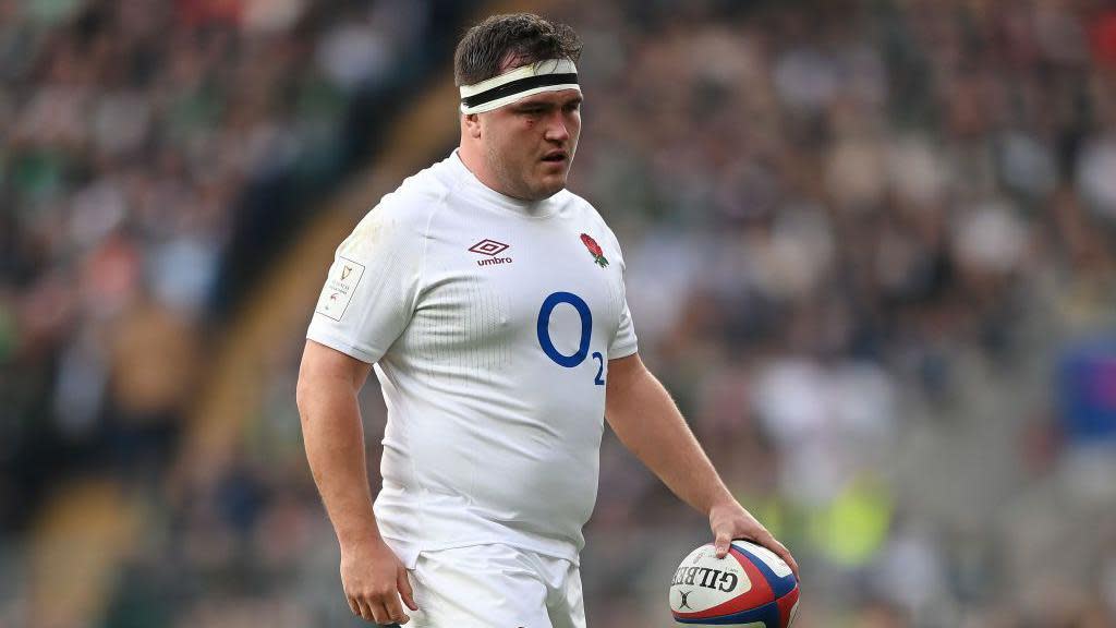 Jamie George holds a rugby ball