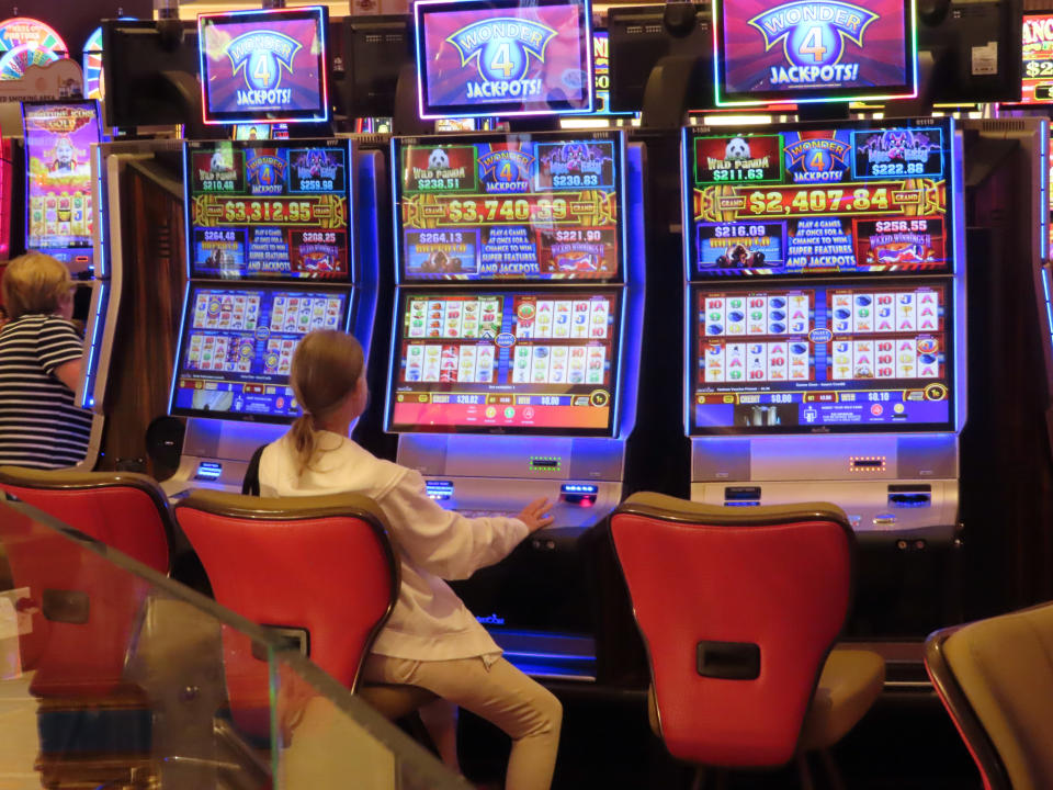 A gambler plays a slot machine at the Hard Rock Casino in Atlantic City, N.J., on Aug. 8, 2022. Figures released on Nov. 9, 2022, by the American Gaming Association show the U.S. commercial casino industry had its best quarter ever, winning over $15 billion from gamblers in the third quarter of this year. (AP Photo/Wayne Parry)