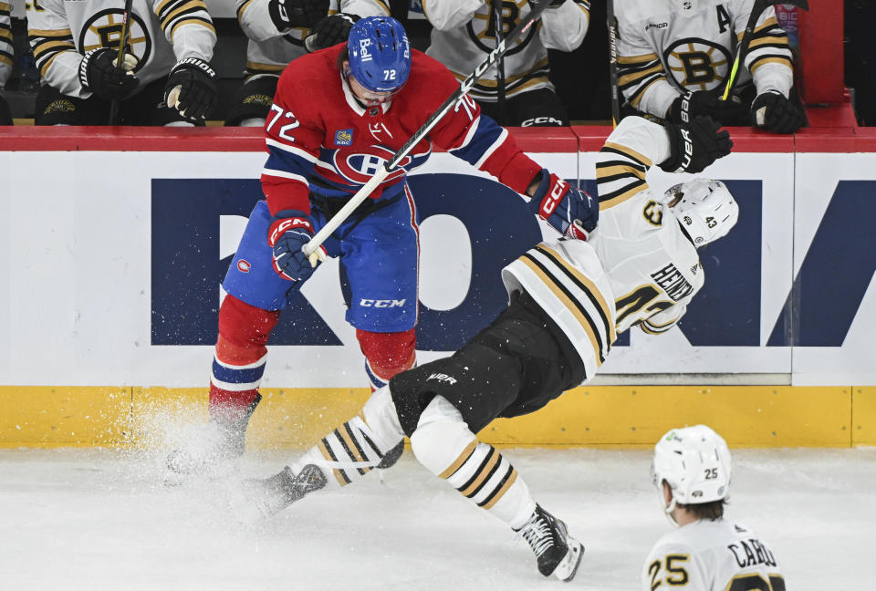 Montreal Canadiens' Arber Xhekaj (72) checks Boston Bruins' Danton Heinen (43) during second-period NHL hockey game action in Montreal, Saturday, Nov. 11, 2023. (Graham Hughes/The Canadian Press via AP)