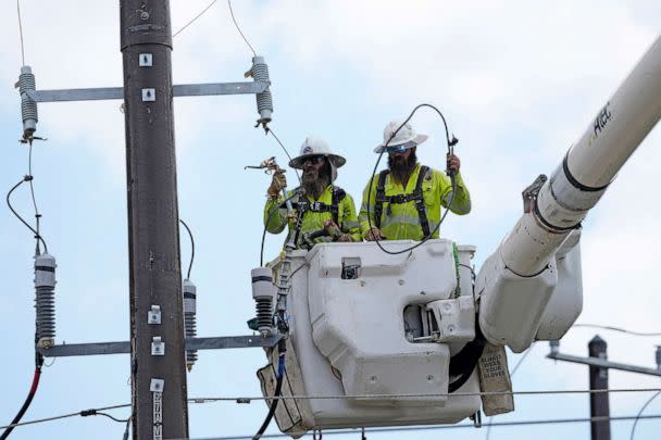 PHOTO: Workers repair a power line, June 29, 2023, in Houston, as an unrelenting heat wave in Texas put extra demand on the system. (David J. Phillip/AP)
