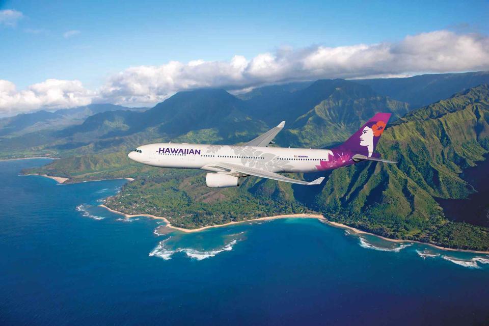 <p>Chad Slattery/Courtesy of Hawaiian Airlines</p> A Hawaiian Airline A330 flying over Tunnels Beach in Kauai County, Hawaii