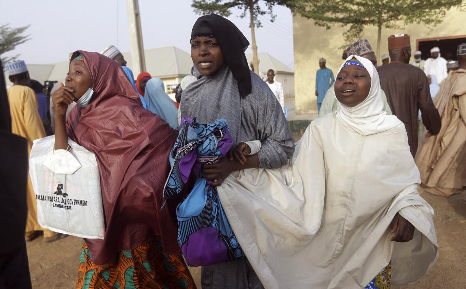 Parents are reunited with their daughters in Jangabe, Nigeria, Wednesday, March 3, 2021. More than 300 schoolgirls kidnapped last week in an attack on their school in northwest Nigeria have arrived in Jangabe after been freed on Tuesday. The Girls were abducted few days ago from Government Girls Secondary School in Jangabe in Zamfara state (AP Photo/Sunday Alamba)