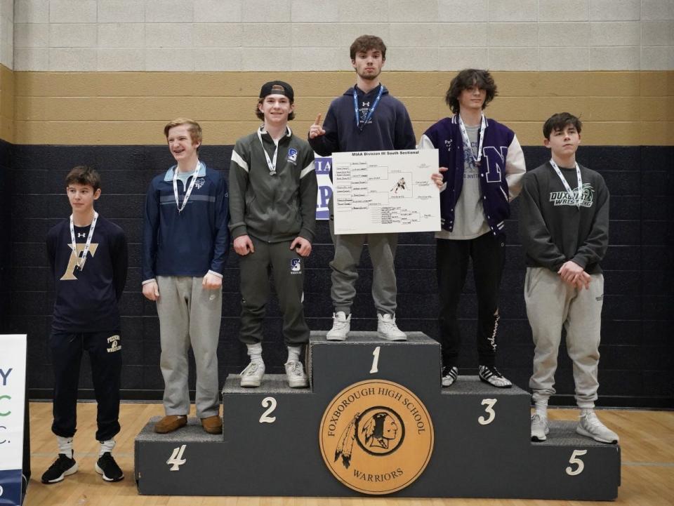 Avery DeOrsey stands atop the podium after his Section Championship in the 120 pound weight class.