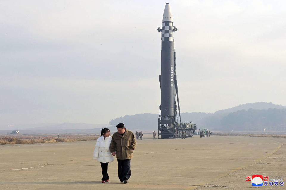 This picture taken on November 18, 2022 and released from North Korea's official Korean Central News Agency (KCNA) on November 19, 2022 shows North Korea's leader Kim Jong Un (R) walking with his daughter is presumed to be Ju Ae  as he inspects a new intercontinental ballistic missile (ICBM) 
