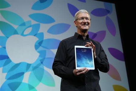 Apple Inc CEO Tim Cook holds up the new iPad Air during an Apple event in San Francisco, California October 22, 2013. REUTERS/Robert Galbraith