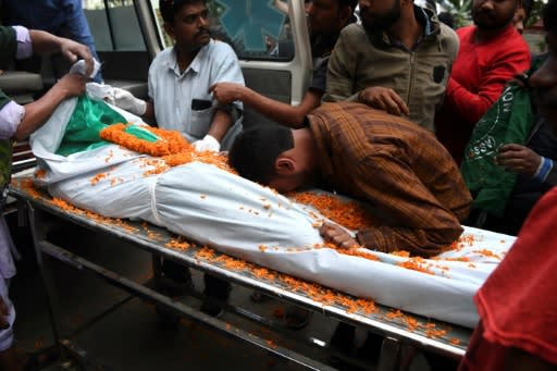 A man weeps over the body of a relative killed in protests agains a new Indian citizenship law