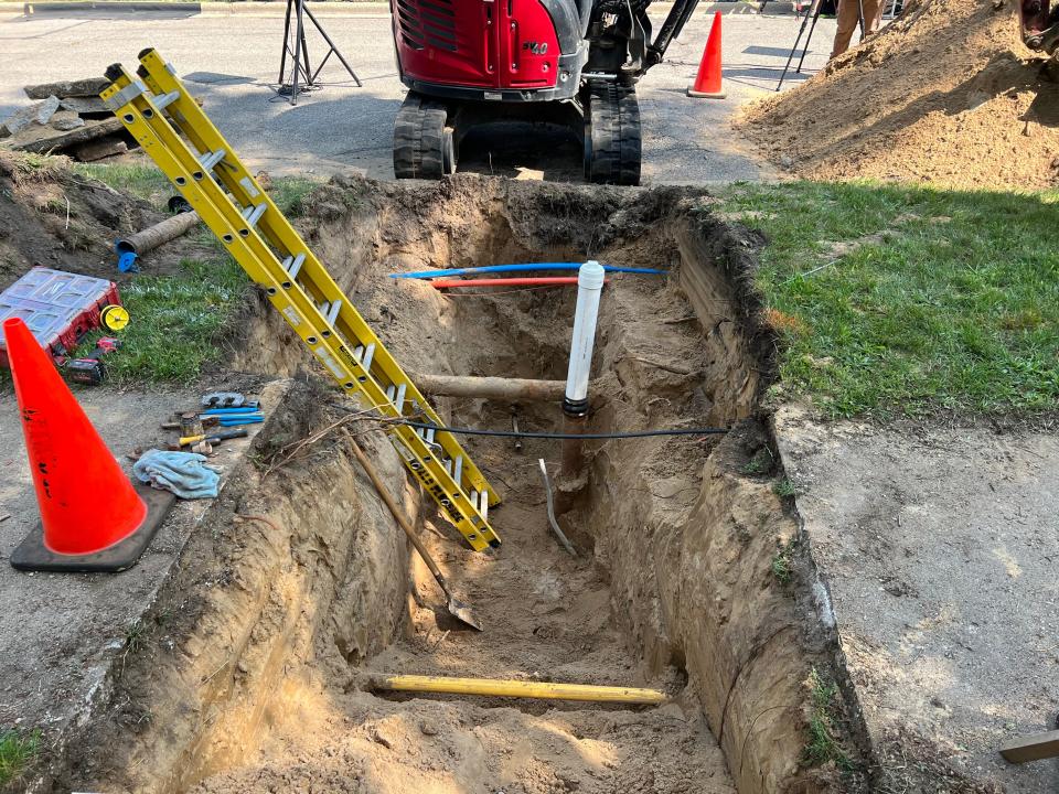 A shovel and ladder rest in a hole dug for a lead service line replacement on Wednesday, July 5, 2023, in Grand Rapids, Mich.