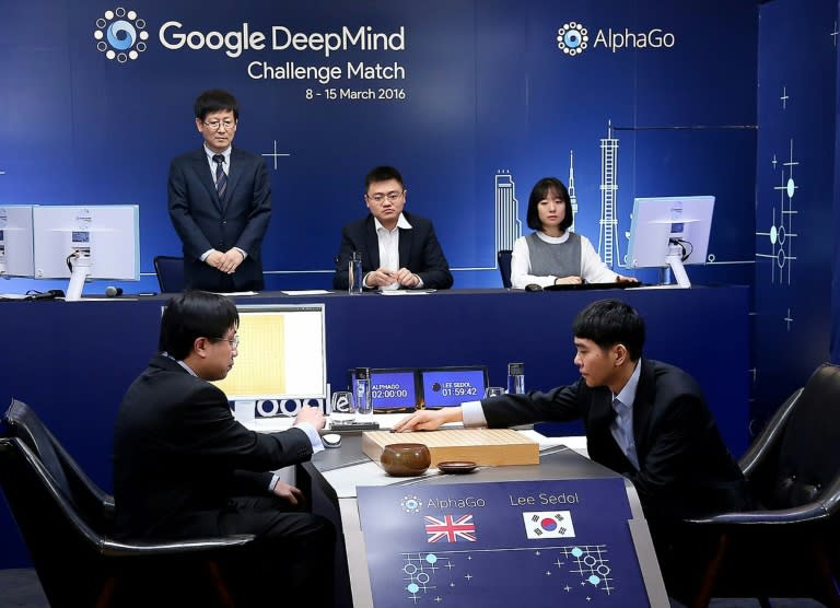 South Korean Go grandmaster Lee Se-Dol (R) is seen in action in the first of the five-game series against AlphaGo in Seoul on March 9, 2016