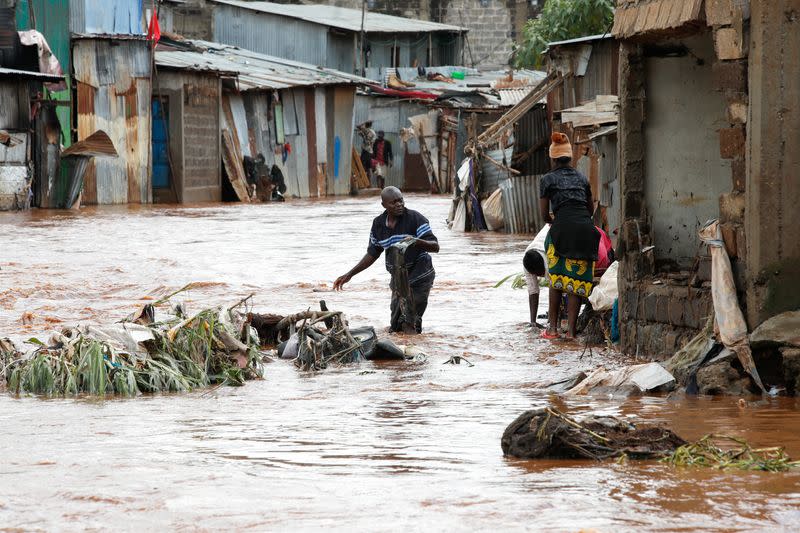 Residents recover their belongings after the Nairobi river burst its banks in Mathare Valley settlement in Nairobi