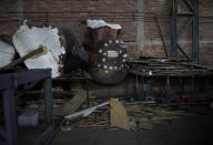 Sculptures designed for parade floats sit unfinished in the Unidos de Padre Miguel samba school workshop, where float construction, costume sewing and dance rehearsals due to the new coronavirus pandemic have been canceled, in Rio de Janeiro, Brazil, Monday, Sept. 21, 2020. The city announced on Thursday, Sept. 24, said it has delayed its annual Carnival parade, saying the global spectacle cannot go ahead in February because of Brazil’s continued vulnerability to the new coronavirus pandemic. (AP Photo/Silvia Izquierdo)