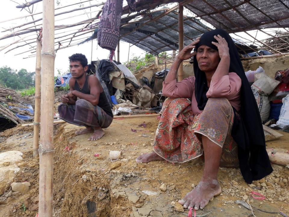 A Rohingya refugee sits near a house destroyed by Cyclone Mora in a camp in the Cox's Bazar district on May 31. Aid workers warned May 31 of an "acute crisis" in Bangladesh after a cyclone destroyed thousands of homes and devastated camps housing Rohingya refugees, leaving many without food or shelter.