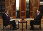 "CBS This Morning" co-host Charlie Rose (L) interviews Syrian President Bashar al-Assad at the Presidential Palace in Damascus, Syria in this September 9, 2013 handout photo. REUTERS/CBS News/Handout