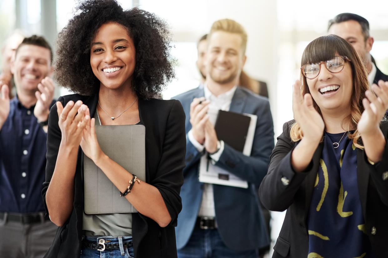 career Shot of a group of businesspeople clapping during a conference